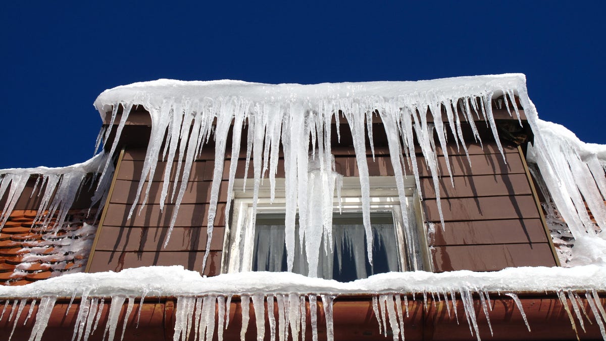 A home with icicles hanging from its eaves.