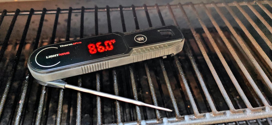 ThermoPro Lightning Instant-read meat probe on and sitting in a grill