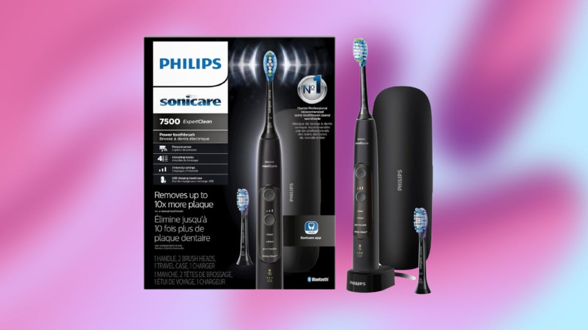 From left: Philips Sonicare brand box with black electric toothbrush against pink background.