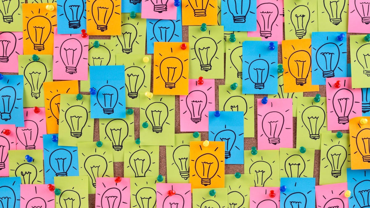 An image of many multicolored post-it notes with light bulbs drawn on them gettyimages-152955834