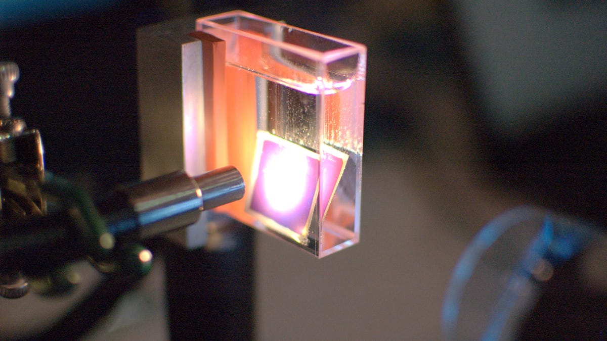 Making hydrogen gas (the bubbles) from a solar cell in water, a Sun Catalytix prototype.