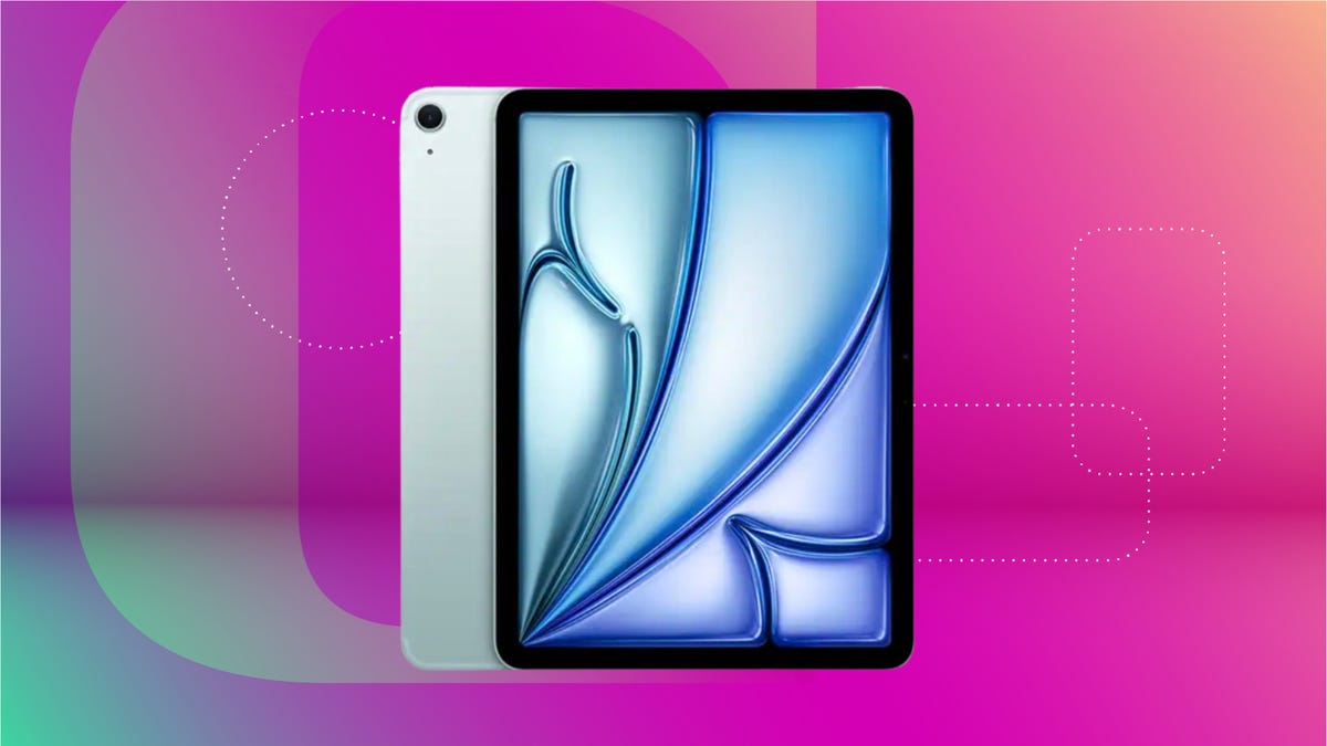 Grey iPad with blue wallpaper against magenta gradient background.