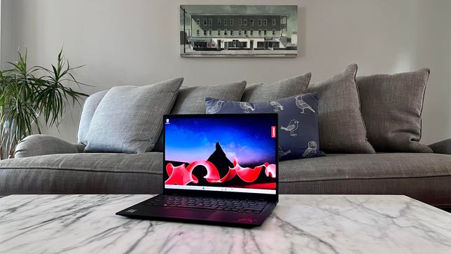 Lenovo ThinkPad X1 Carbon Gen 11 laptop on a coffee table in front of a couch