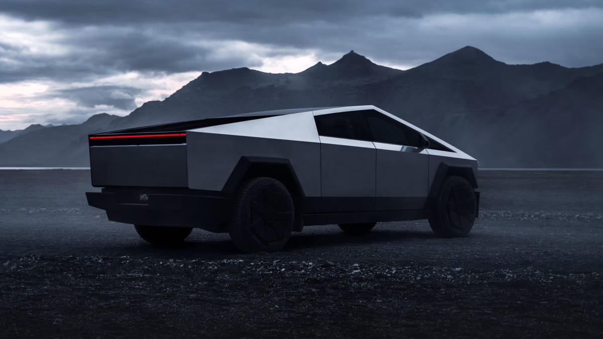 Tesla Cybertruck on a dark plane, angled away