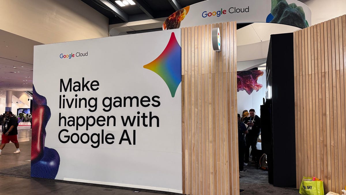 A booth on a convention floor with words listed on the side: "Make living games happen with Google AI."