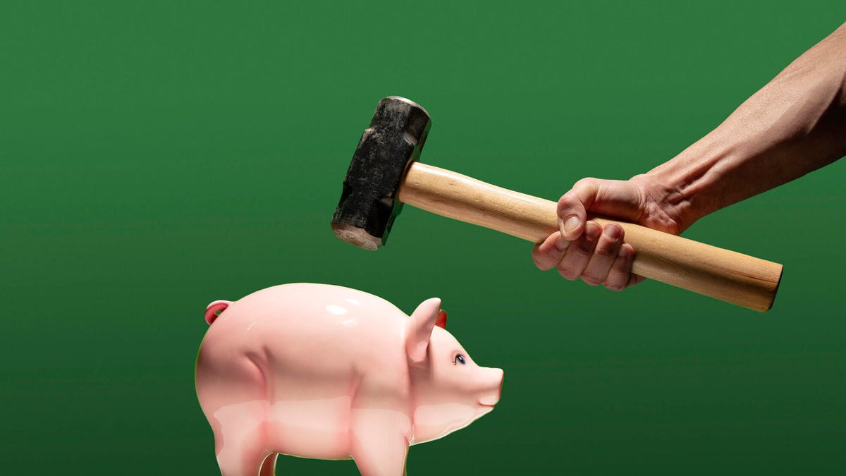 Person about to smash piggy bank