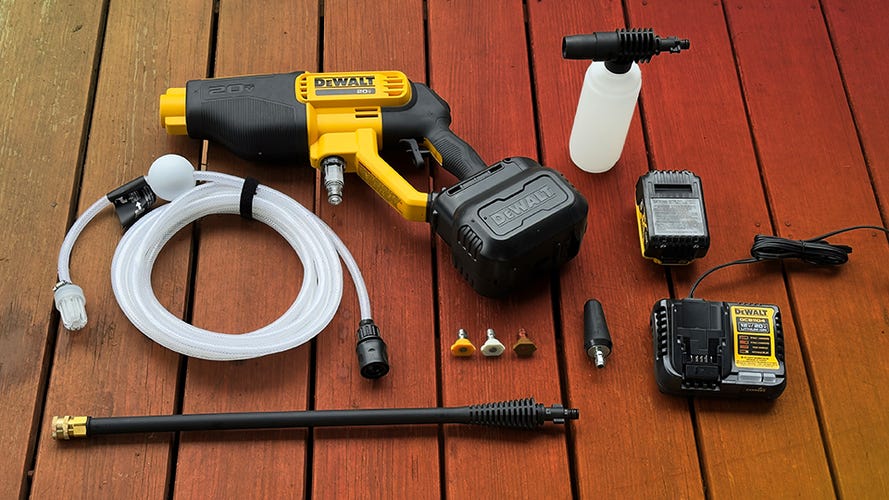 The Dewalt handheld pressure washer pictured with its accessories. 