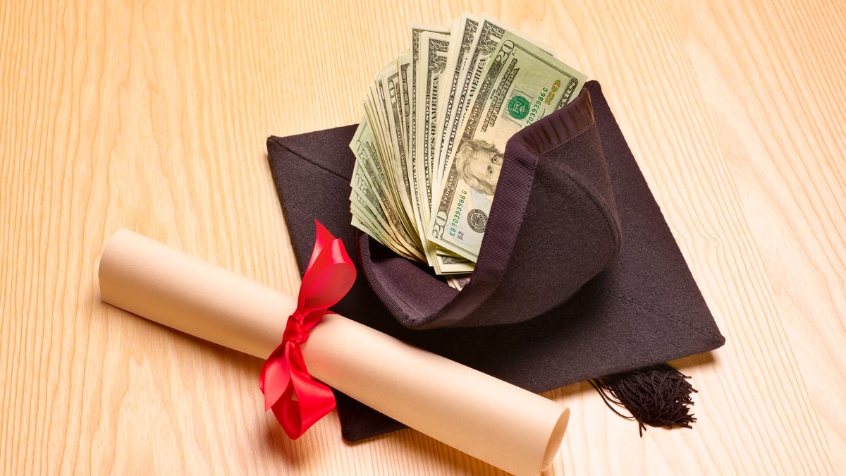 Mortarboard with diploma and cash