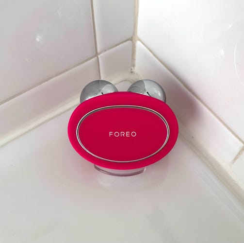 The FOREO Bear 2 device on a white bathroom countertop.