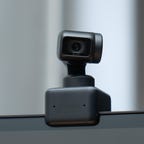 Insta360 Link webcam perched on top of a monitor