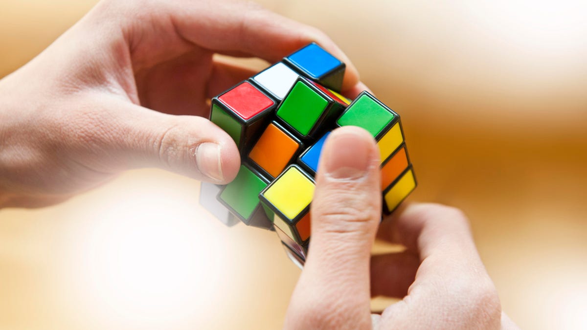 Hands playing a cube game