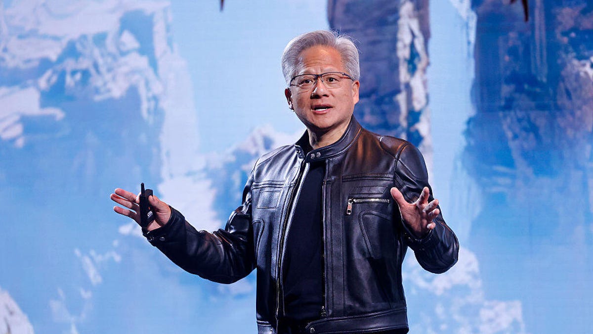 Jensen Huang, wearing a leather jacket, in front of a screen.