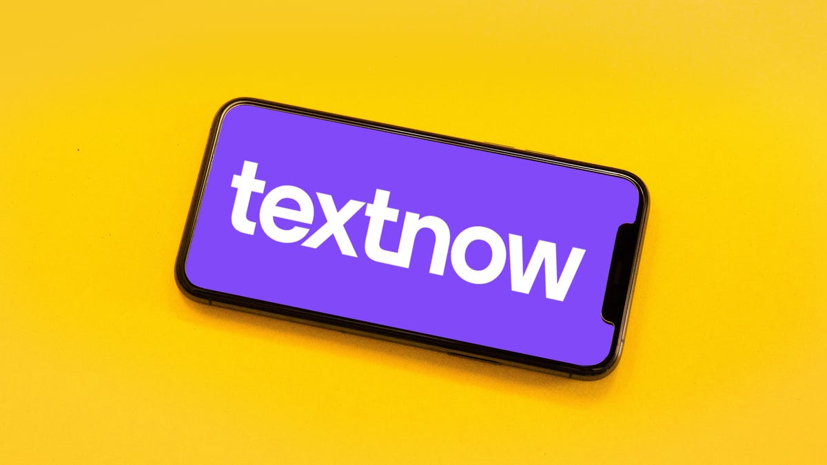 Mobile phone with the TextNow company logo against a purple background. The phone is on a bright yellow background.