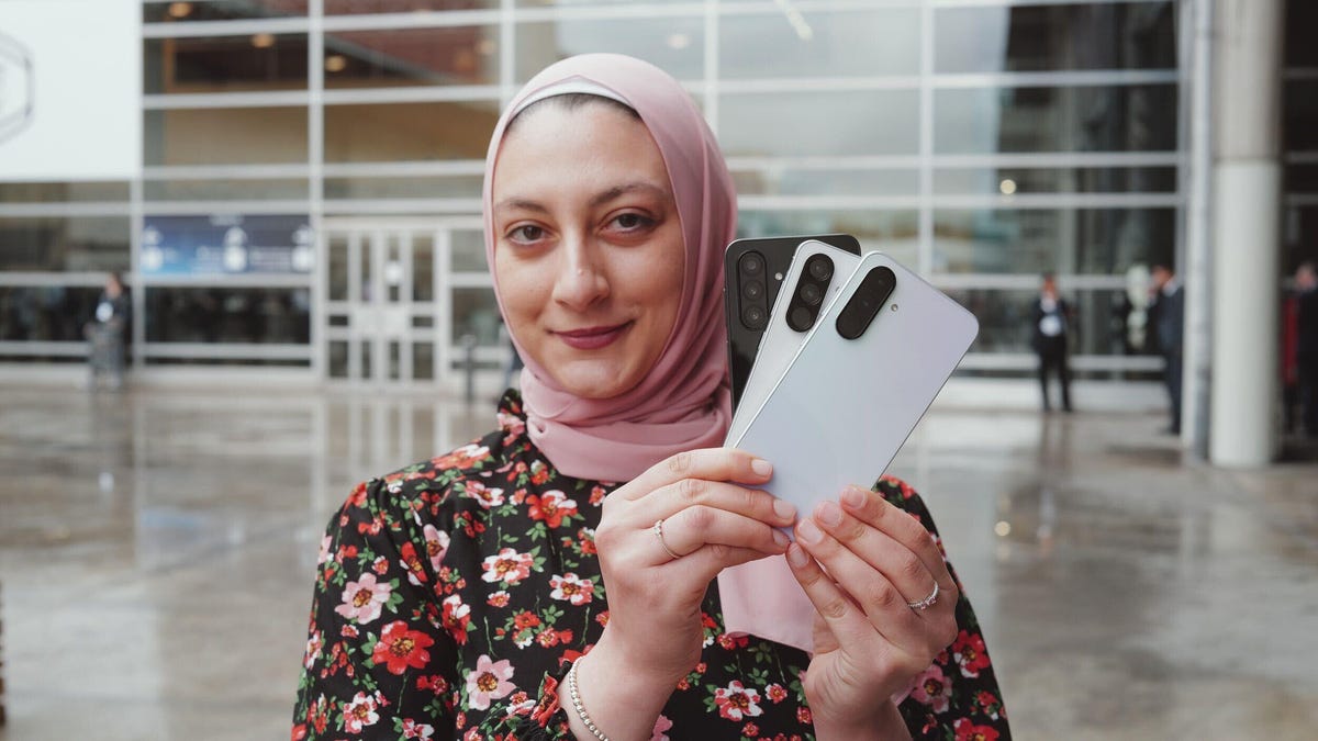A woman holding the Galaxy A26, Galaxy A36, Galaxy A56 at MWC
