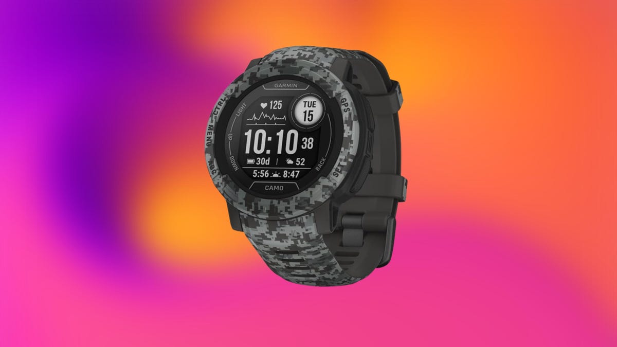 Garmin Instinct 2 smartwatch in camo on an orange and purple background.