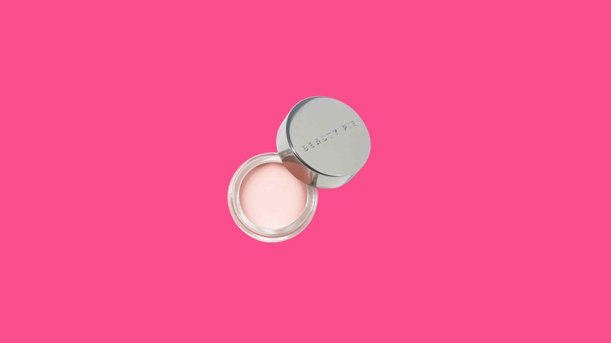 Beauty Pie's tinted eye cream on top of a colorful background.