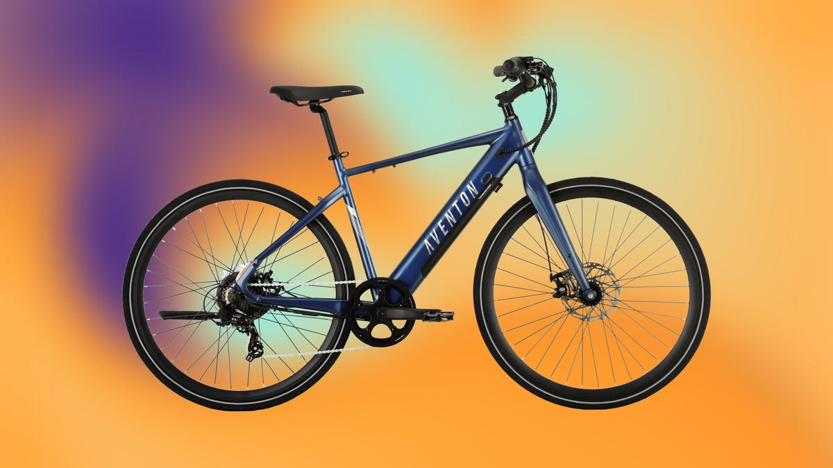 A blue e-bike against an abstract orange and purple background.
