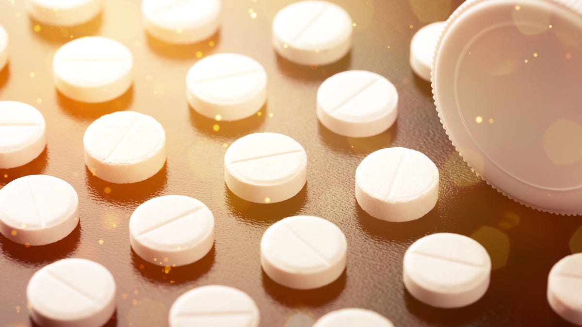 Adderall pills lined up neatly against an orange glow