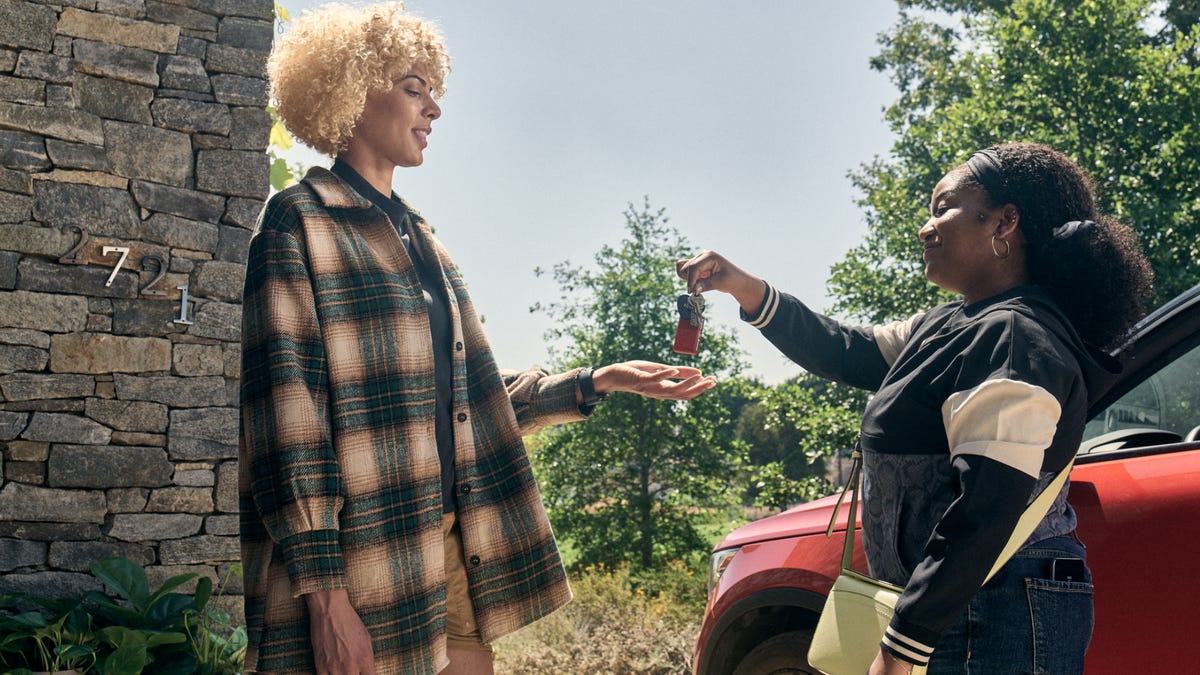two women exchange car keys