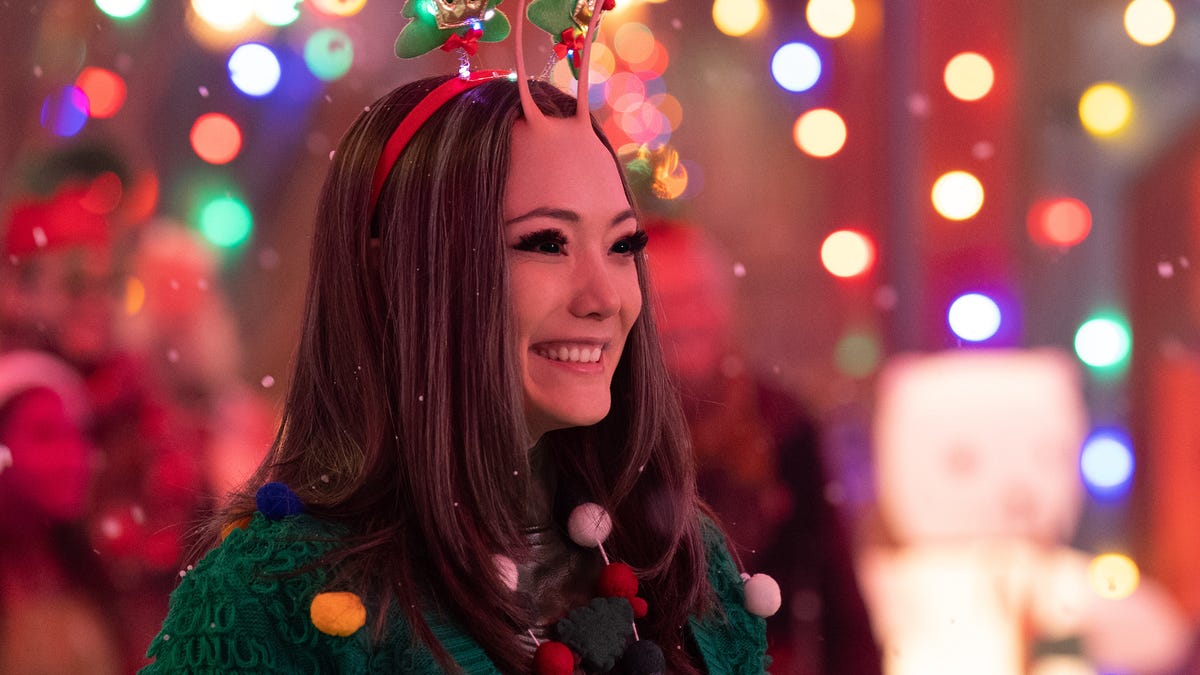Cheerful alien Mantis grins in a Christmas outfit in the Guardians of the Galaxy Holiday Special