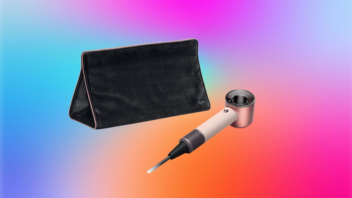The Dyson Supersonic Travel hair dryer beside a black case with a CNET background