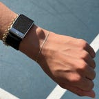 A hand with the Whoop 5.0 on the wrist.