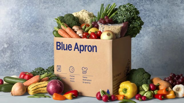blue apron box with ingredients spilling out