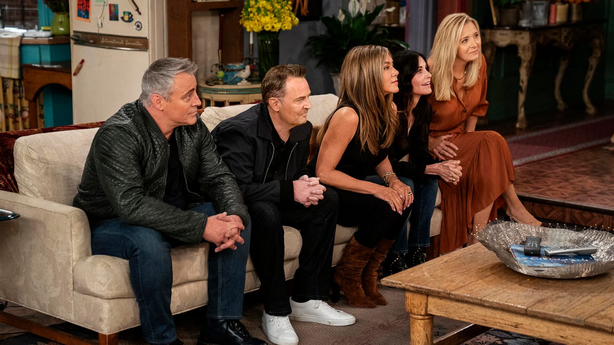 Friends cast sitting on couch during reunion