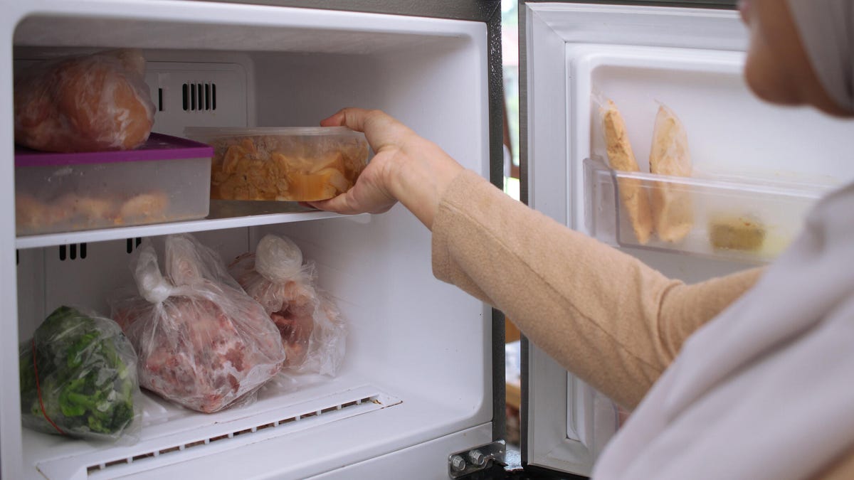 person removing food from freezer