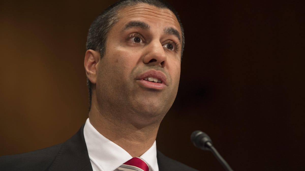 Chairman Ajit Pai of the Federal Communications Commission at microphone, giving testimony to lawmakers in June. A group of Senators asked Pai to investigate phony public comments before holding a vote on the rollback of net neutrality regulations in a letter on Monday.