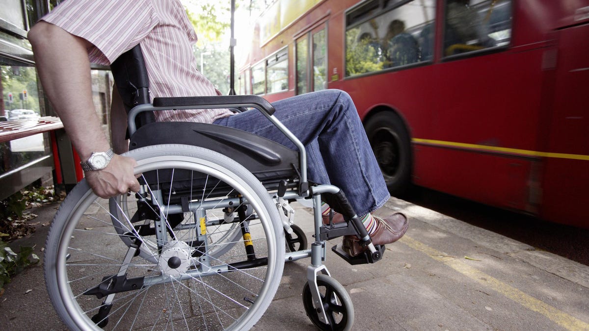 Disabled man in wheelchair at bus stop