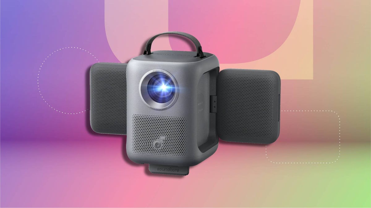 Compact smart projector with a rotating lens and built-in speaker on CNET background.