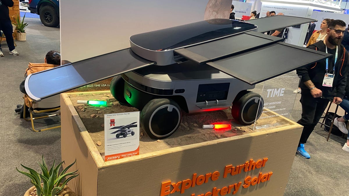 A "Mars rover" with solar panels extending from the top of it.