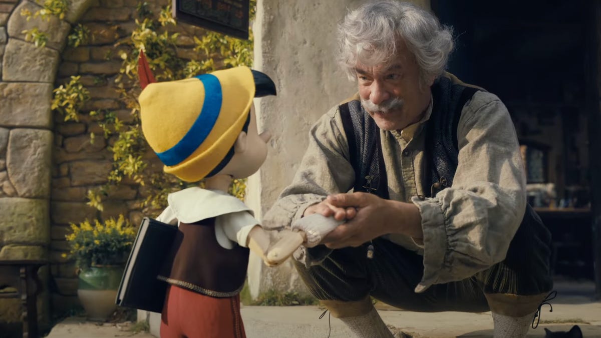 Tom Hanks as Geppetto talks with Pinocchio