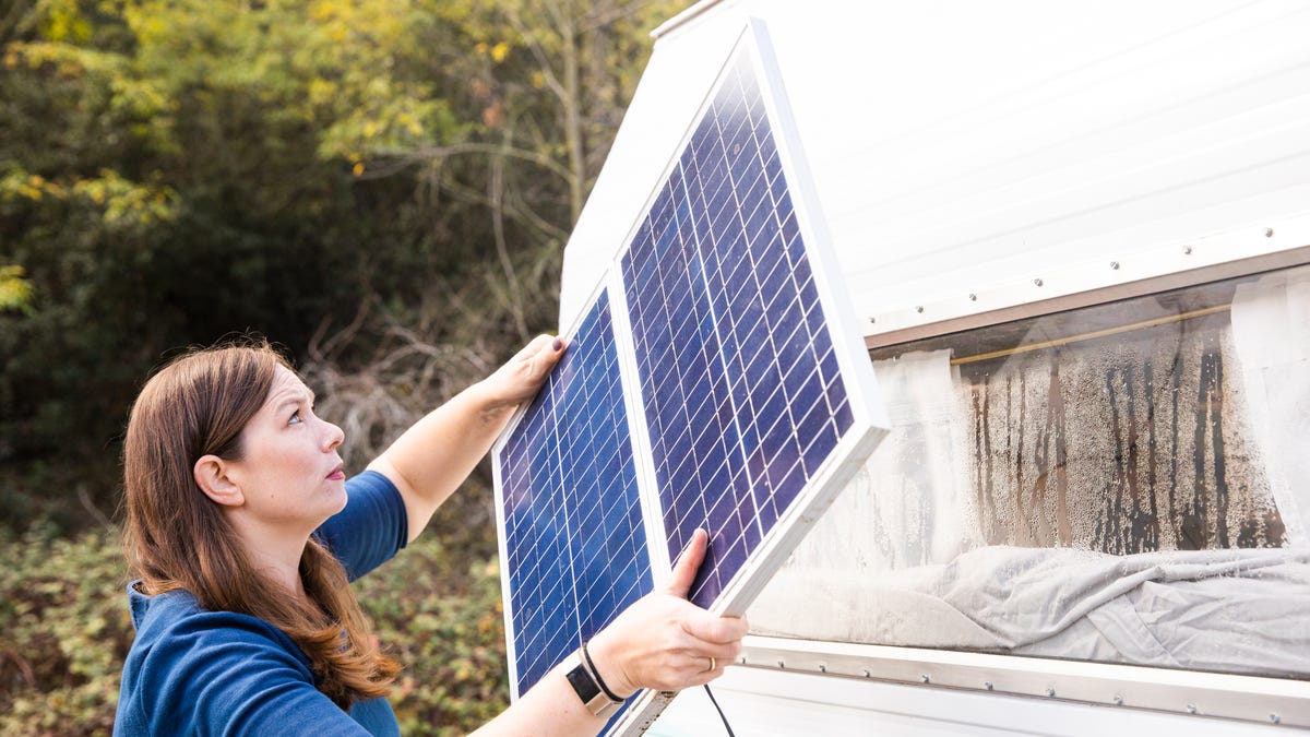 Woman holding solar panel