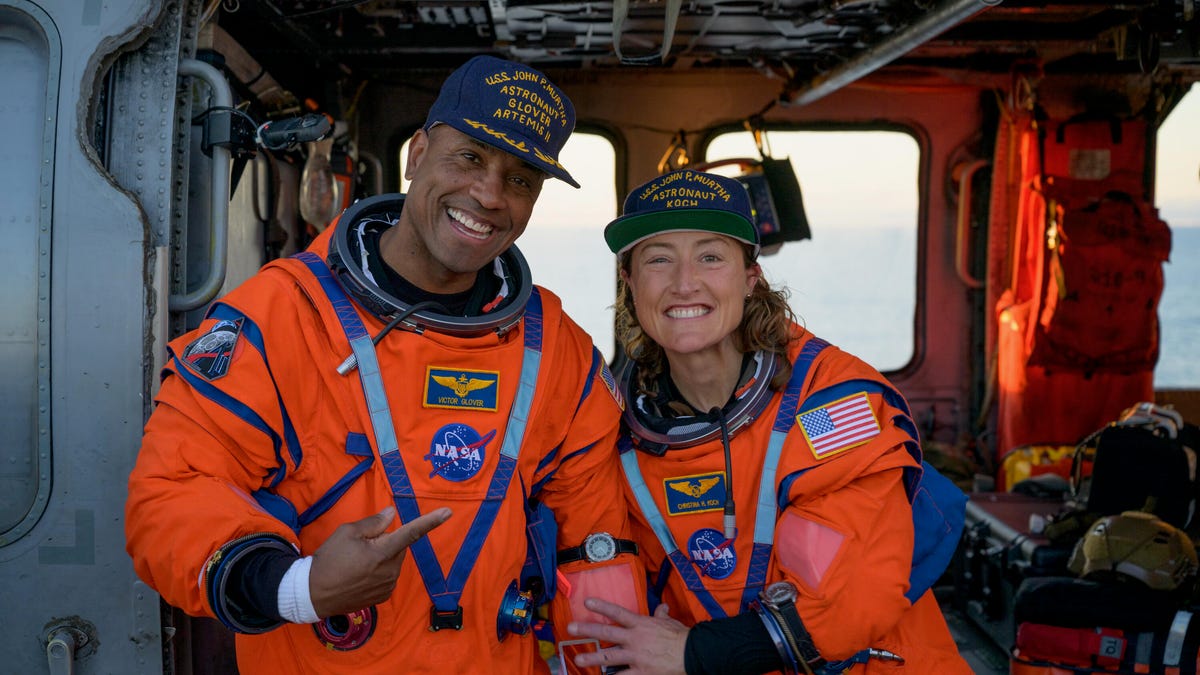 Two Artemis II astronauts in a helicopter