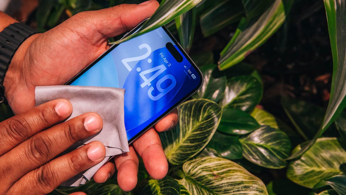 Wiping down a phone with a gentle cloth