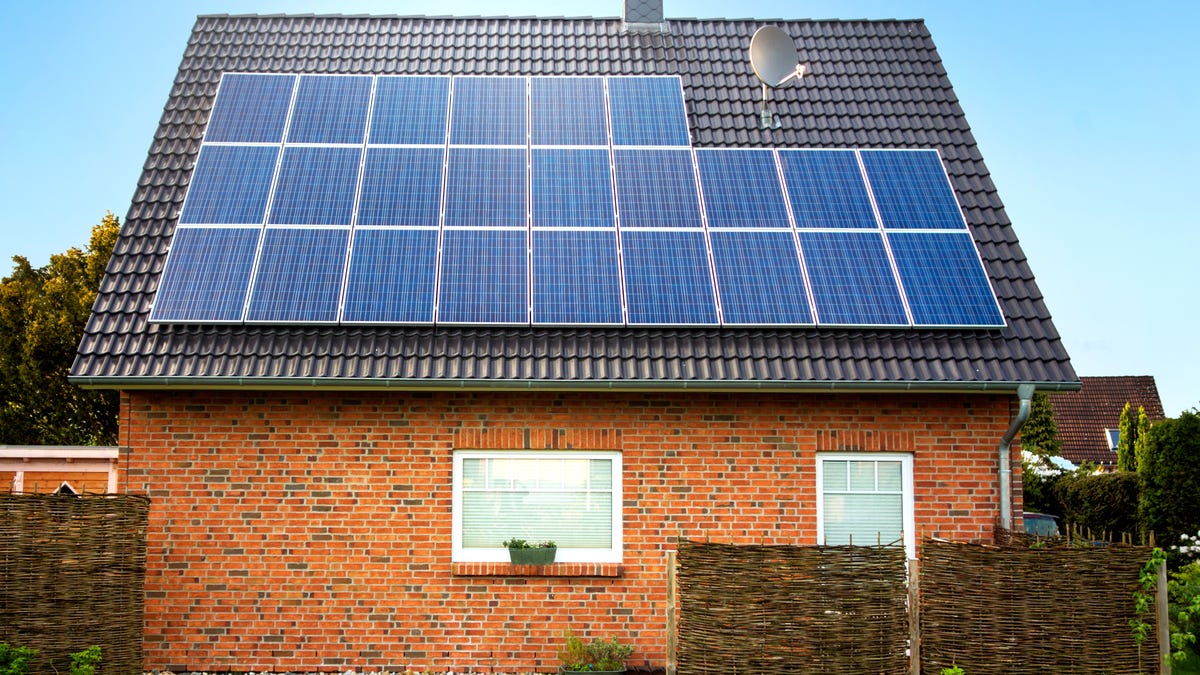 Solar panels on the roof of a brick house