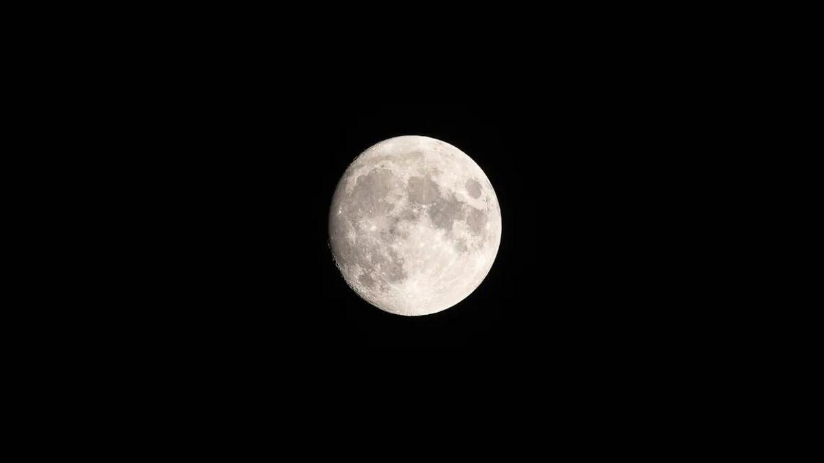 Picture of a nearly full moon, centered in the jet black of space.