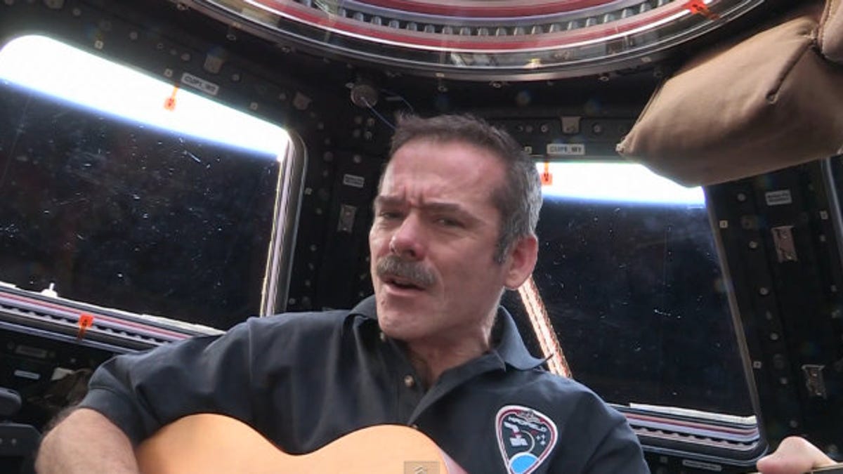 Chris Hadfield with guitar in space