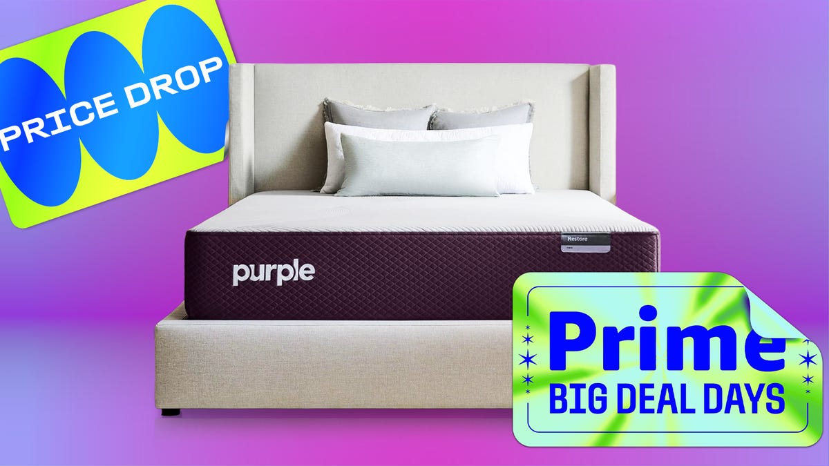 Purple mattress on bed frame against purple and pink background.