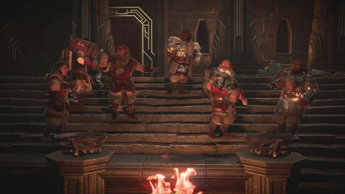 Dwarves gather on stone steps in a shadowy mine, lit by a fire, in Lord of the Rings: Return to Moria