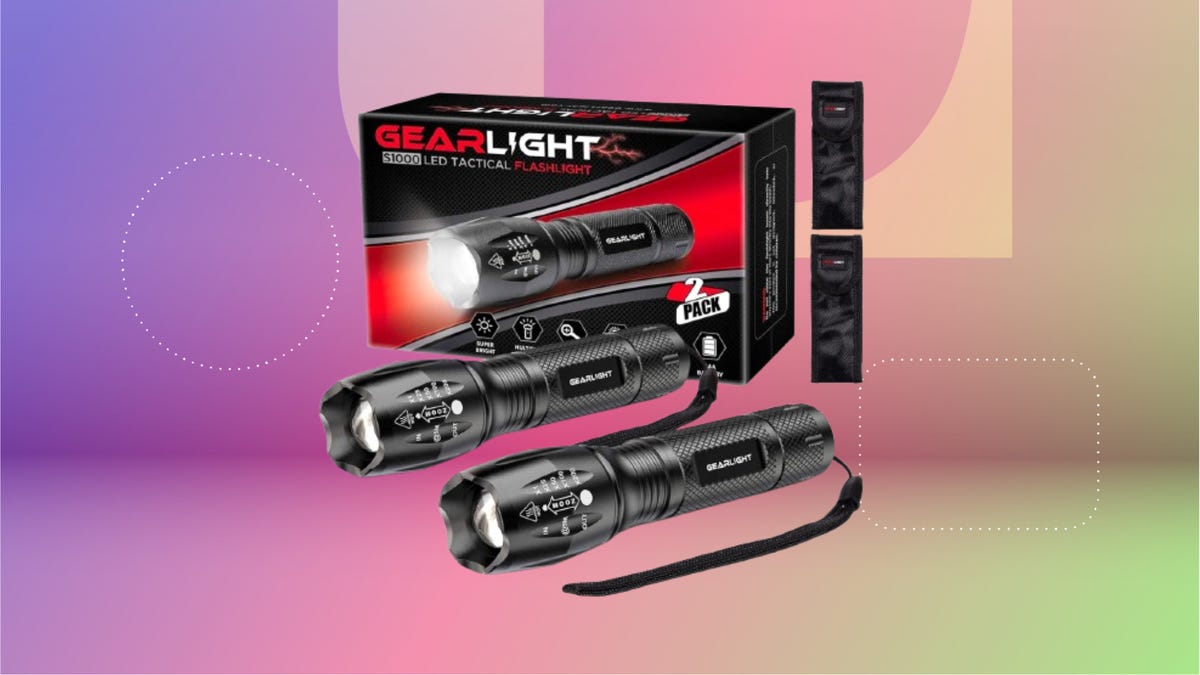 Two black mini flashlights against GearLight box. Background: purple, pink and green.