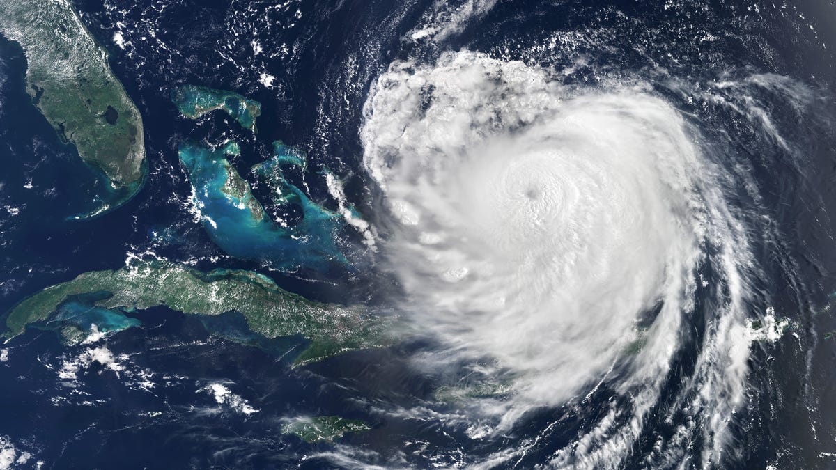 a satellite picture of Hurricane Erin from Aug. 16, 2025. a massive swirl of white clouds is positioned to the east of southern Florida
