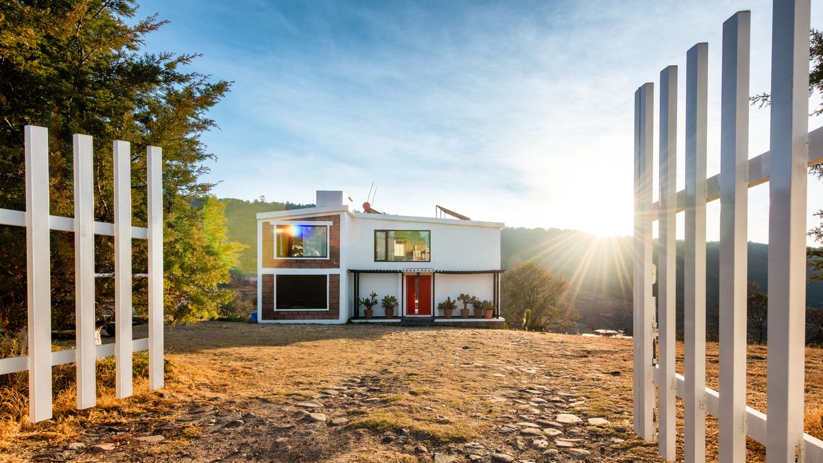 A home with a modern design and roof top solar panels.
