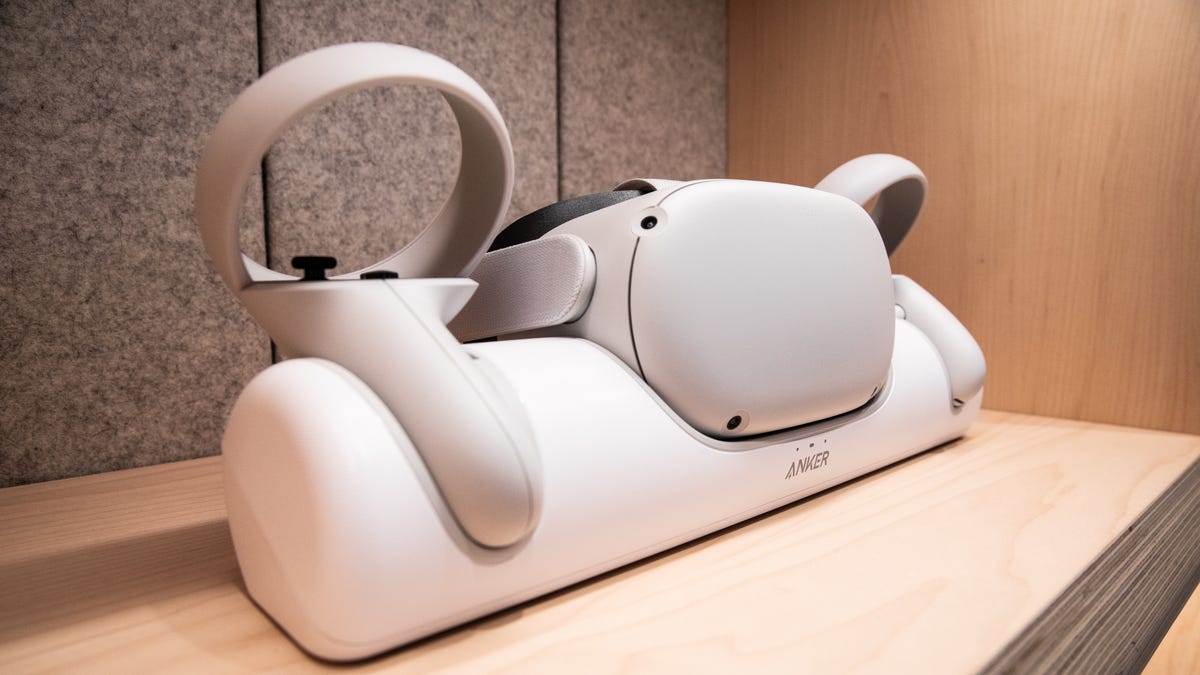 Quest VR headset and controllers sit in an Anker charging dock