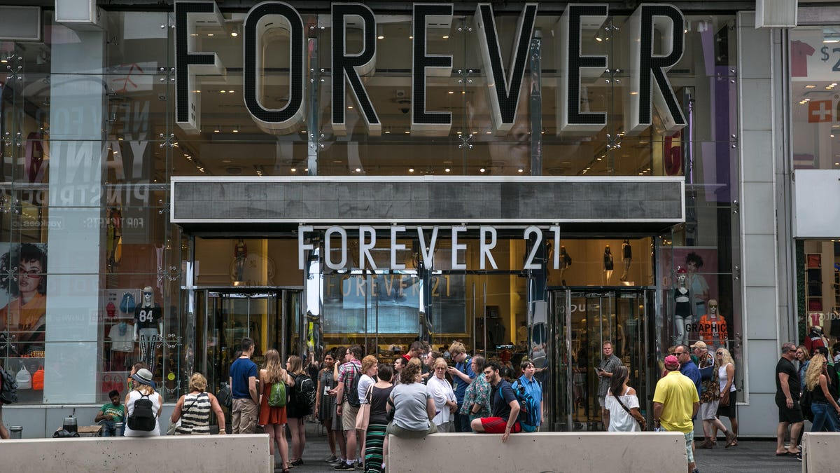A crowd of people gather outside the Forever 21 store in Times Square in New York City in 2017. The retailer said Thursday hackers infiltrated some point of sales machines at its stores throughout the country.