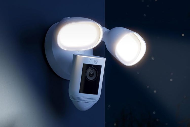 Ring's floodlight camera lit at night.