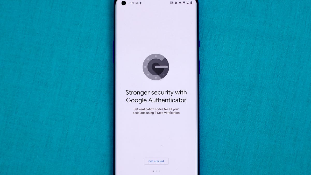 Google Authenticator logo on phone screen.