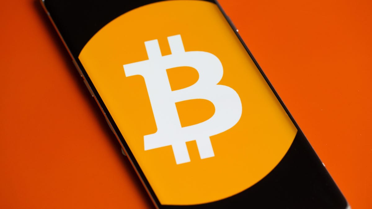Bitcoin logo on a phone screen.